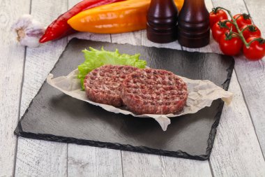 Çiğ burger pirzolası ızgara için hazır.