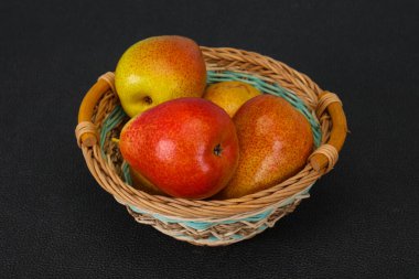 Tahta sepetteki olgun armut yığını.