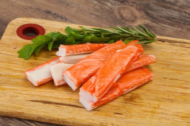 Ahşap tahtanın üzerinde yengeç çubuğu surimi