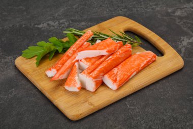 Ahşap tahtanın üzerinde yengeç çubuğu surimi