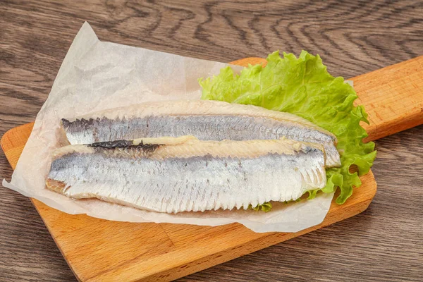 Herring fillet with salad leaves over board — Stock Image Herring Fillet Salad Leaves Board Stock Photo