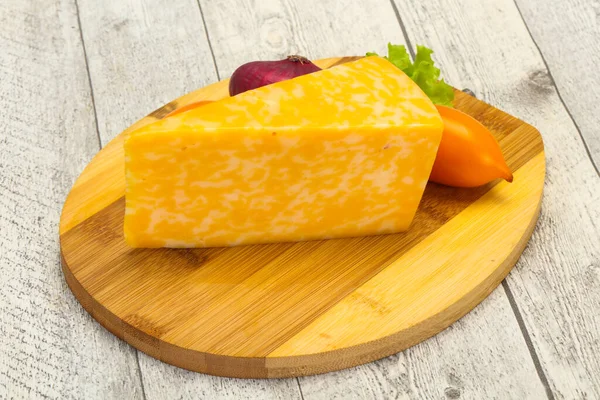 Marble cheese  triangle over wooden background