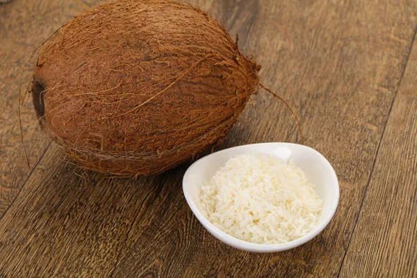 Coconut shredded chip with nut over wooden background