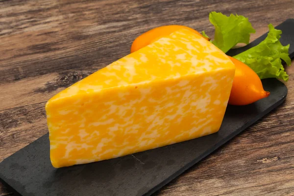 Marble cheese  triangle over wooden background