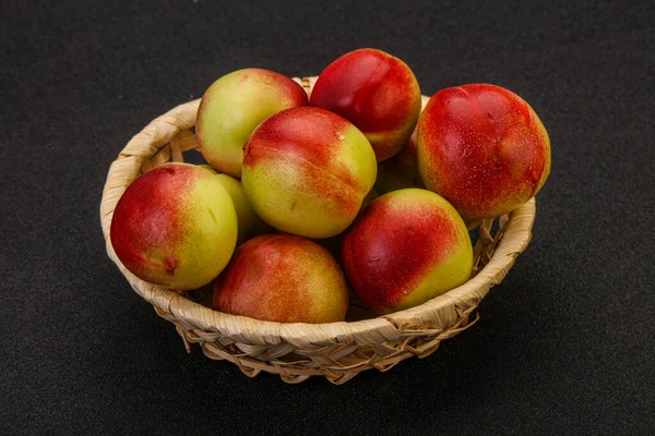Sweet small green nectarines in the basket