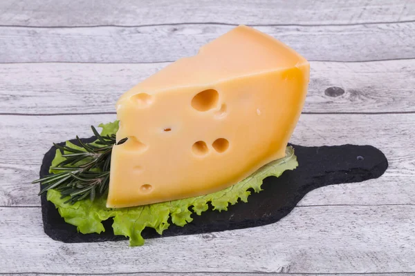 stock image Maasdam cheese on the board served salad leaves and rosemary