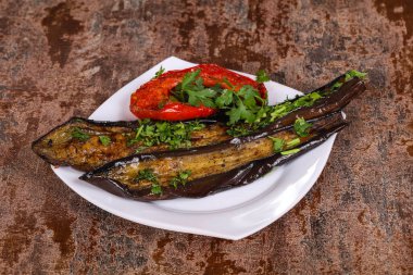 Dolmalık biberli ızgara patlıcan yeşil otlar ve baharatlar servis edilir.