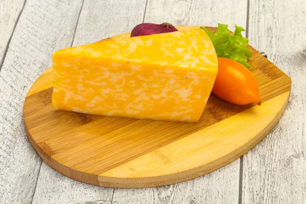 Marble cheese  triangle over wooden background