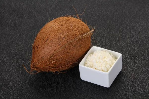 Coconut shredded chip with nut over wooden background