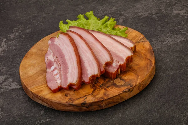Tasty smoked pork brisket slice over wooden board