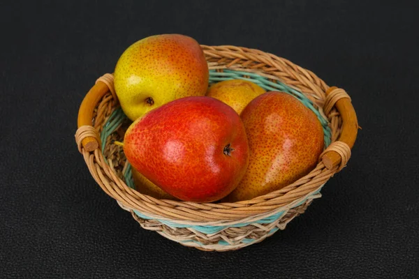 Tahta sepetteki olgun armut yığını.