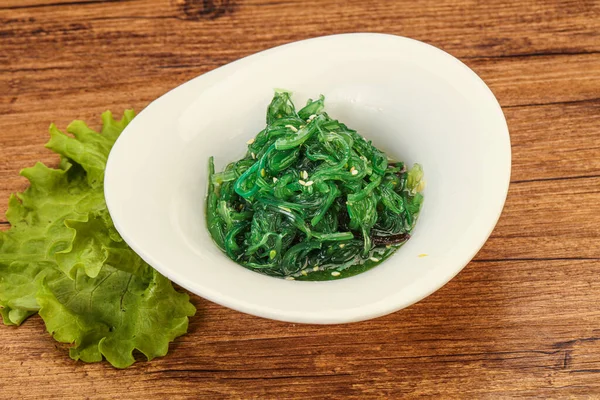 Green Chuka Seaweed Salad Isolated on White Background Top View. Wakame Sea Kelp Salat, Chukka Sea Weed, Healthy Algae Food