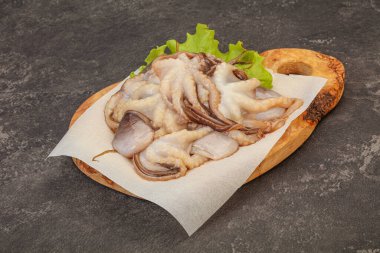 Çiğ deniz ürünleri - ahtapot tahtada pişirmek için.