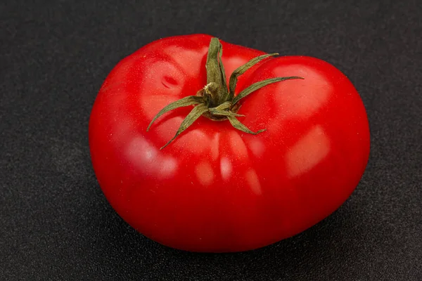 Ripe tasty red big tomato over background