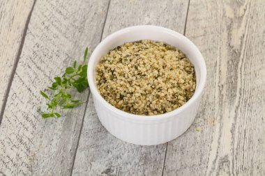 Ahşap arka planda kabuktaki kenevir tohumları.