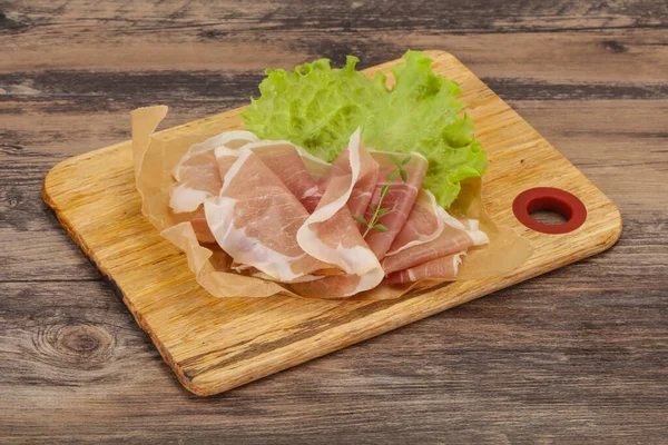 Italian prosciutto pork meat snack over board