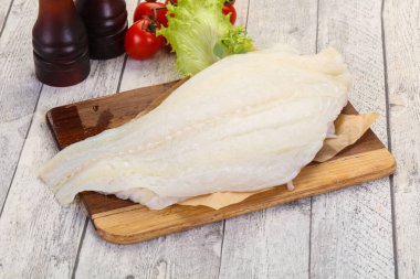 Raw halibut fillet ready for cooking clipart