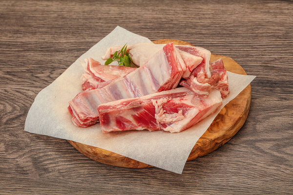 Raw lamb ribs served rosemary for cooking