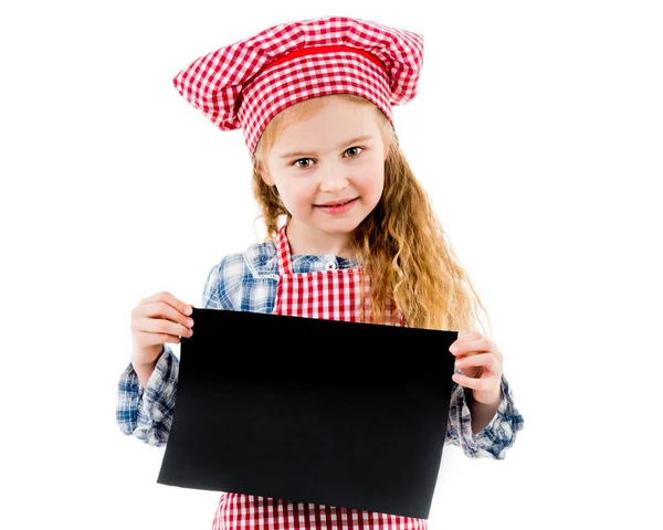 Little girl in chef uniform with blank paper — Stock Photo, Image
