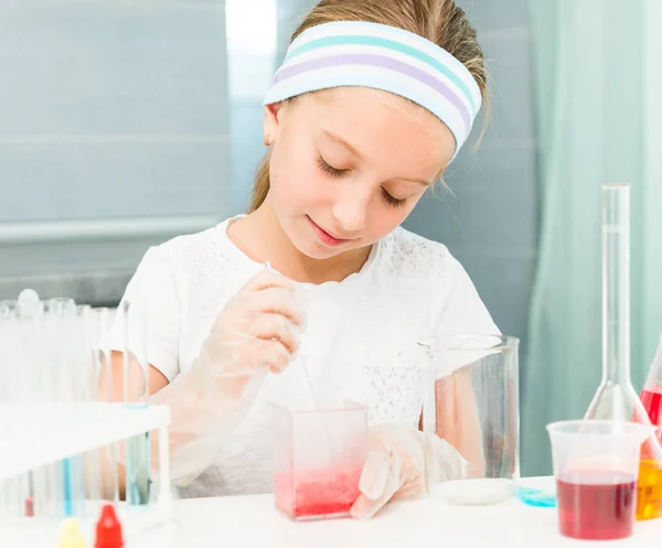 Little girl with flasks for chemistry — Stock Photo, Image