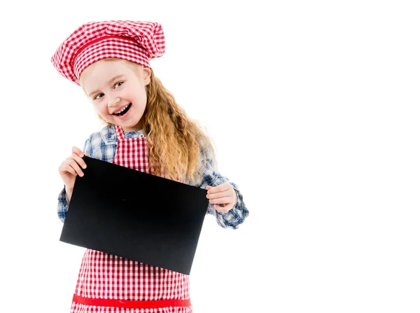 Little girl in chef uniform with blank paper — Stock Photo, Image