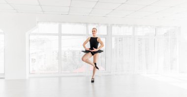 Young ballerina practising ballet moves clipart