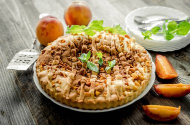 Eski ahşap bir masada şeftalili turta