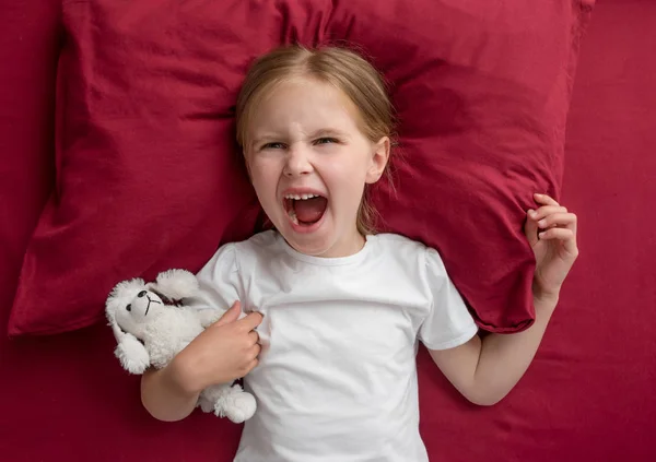 Enfant fille couché sur le lit refuse de dormir — Photo