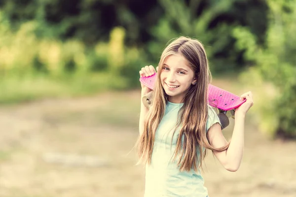 Teenage girl holding her pink board — Stock Photo, Image