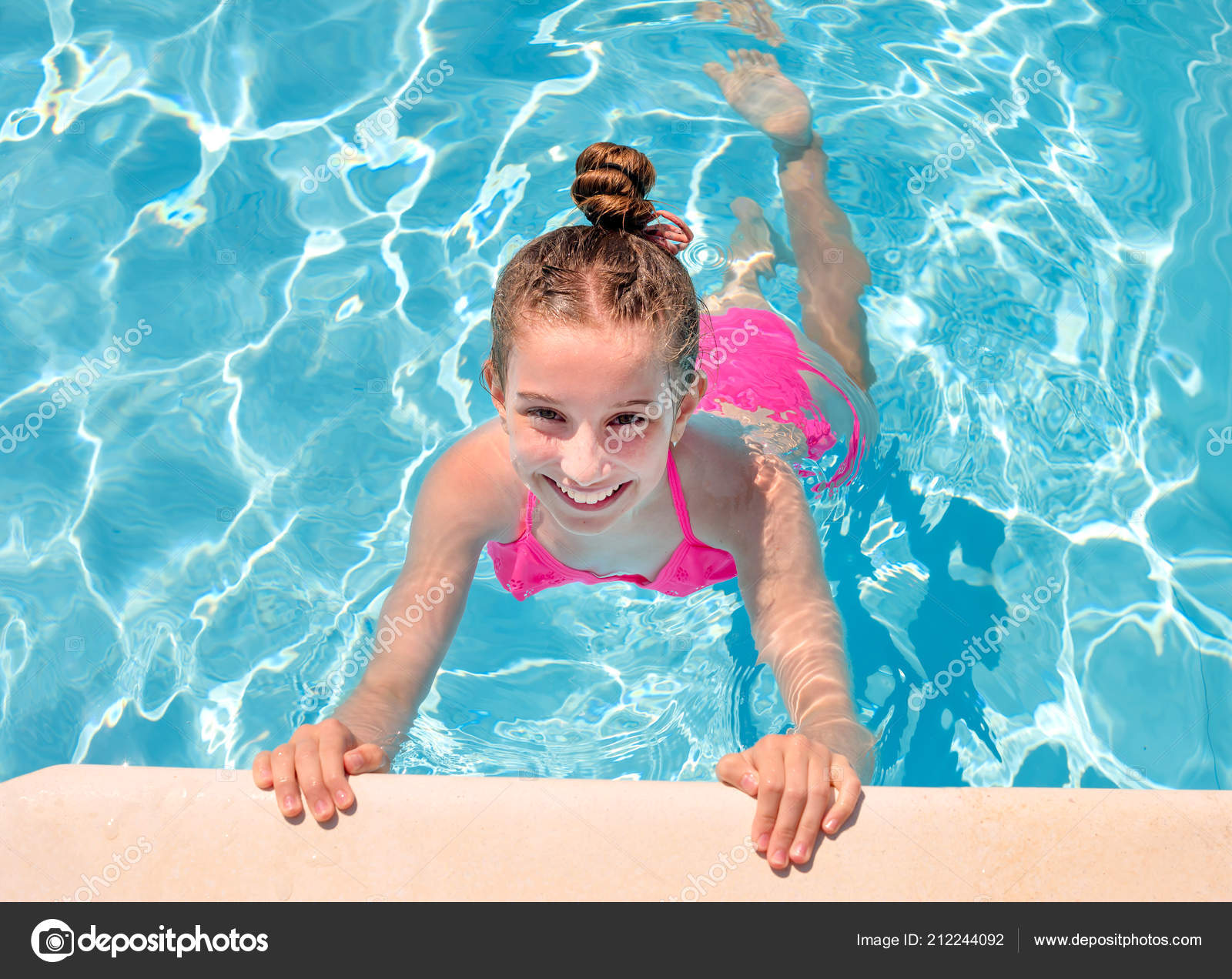 Teen girl in swimming pool squinting her eyes Stock Photo by ©tan4ikk  212244092