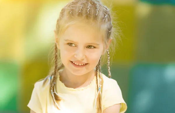 Cute little girl smiling in the morning park — Stock Photo, Image