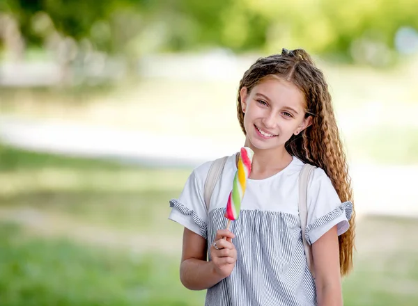 Cute curly teenager girl eating ice cream — Stock Photo, Image