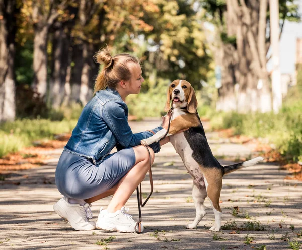 Blond girl sitting with puppy — Stock Photo, Image