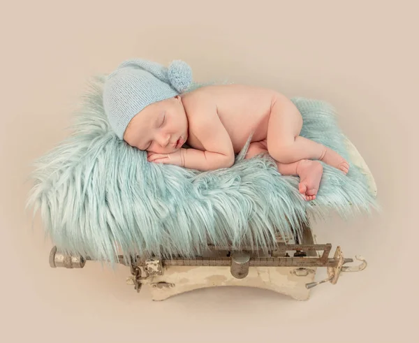 Little baby sleeping on blue pillow on scales — Stock Photo, Image