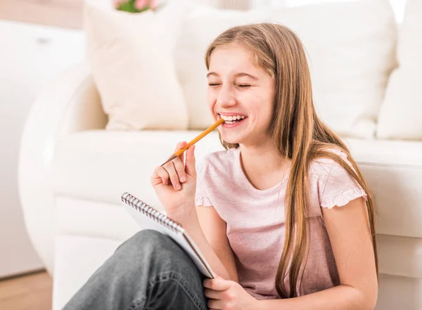 Lächelndes Mädchen zeichnet Bilder — Stockfoto