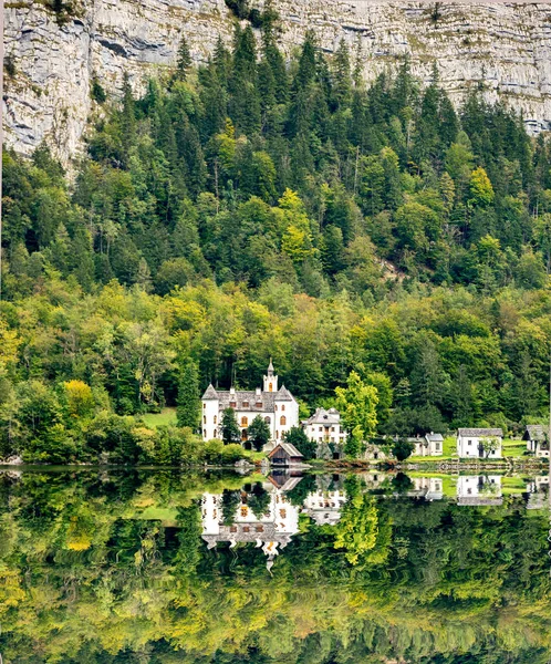 Hidden castle near forest lake in Austria