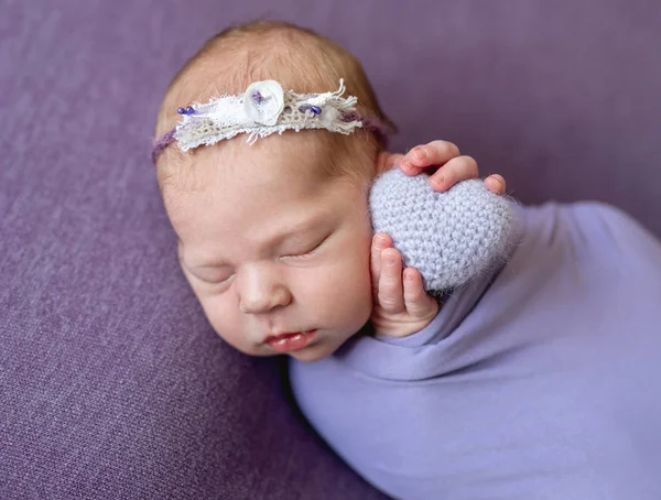Newborn child with knitted heart — Stock Photo, Image