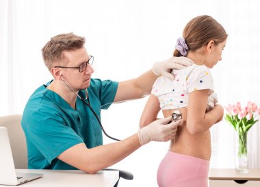 Doctor checking health status of a girl clipart