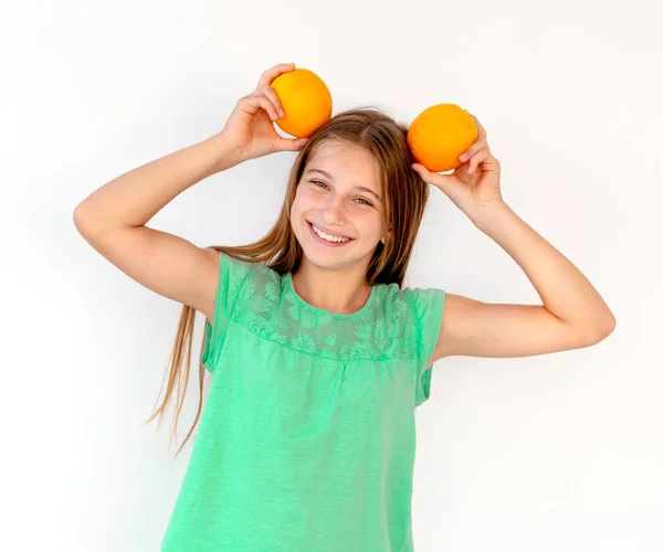 Kislány friss narancssárga gyümölcsök — Stock Fotó