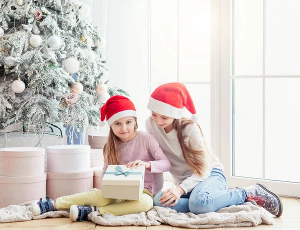 Hermanas abren regalos de año nuevo —  Fotos de Stock