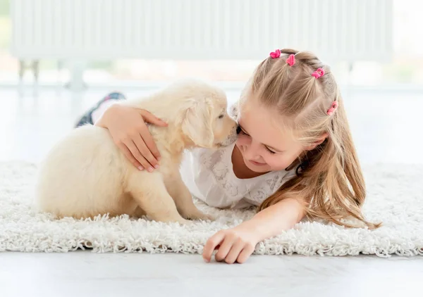 Playful puppy smells happy girl — Stock Photo, Image