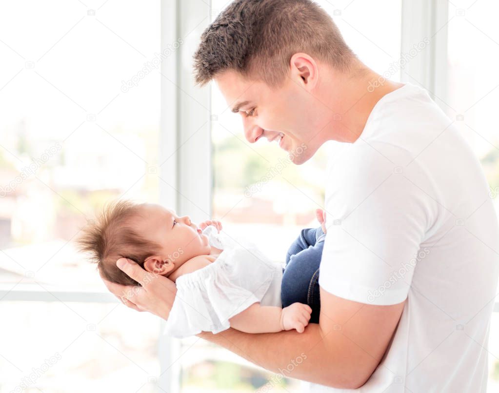 Father embracing infant