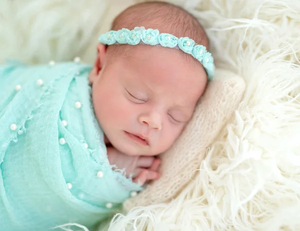 Sleeping newborn in blue headband