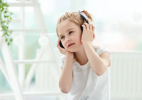 Beautiful little girl wearing headphones — Stock Photo, Image