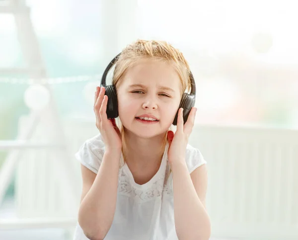 Beautiful little girl wearing headphones — Stock Photo, Image