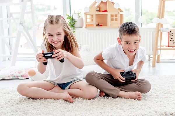 Ragazzino e ragazza giocare video gioco — Foto Stock