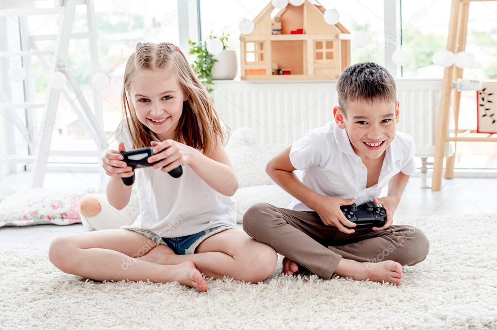 Little boy and girl playing video game