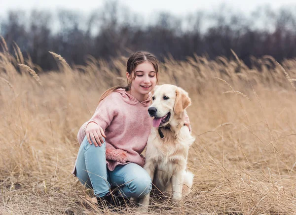 Beautiful girl with dog outside — Stock Photo, Image