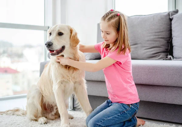 Pretty little girl with golden retriever — Stock Photo, Image