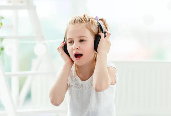 Beautiful little girl wearing headphones — Stock Photo, Image